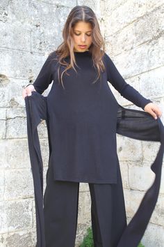 "The beauty of simplicity - this top will serve you well day or night. It is just what you need for a casual day or an evening look. Details: * Long sleeve high neck knit tunic top with side slits & long straps to tie around the waist. * Top length: Front 35.4\" (90 cm), Back 39.4 (100 cm). * Straps measurements - length: 31.5\" (80 cm), Width: 7.87\" (20 cm). * Also suitable for pregnancy and maternity (the open slits on the sides and straps adjust to your body changes) * This top is also a Black Fine Knit High Neck Top, Black High-neck Knit Top For Layering, Black High Neck Knit Top For Layering, Fitted Black Sweater For Loungewear, Fitted Black Long Sleeve Tunic, Fitted Long Tops For Layering, Office Tops For Women, Knit Wrap Top, Loose Shirt Dress