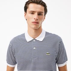 Lacoste, inventors of the polo shirt in 1933, present this bold version of the L.12.12. Made from a supple, elegant piqué fabric with horizontal stripes, inspired by archival designs, which highlight the iconic finish details of the original style. Classic Polo Shirt With Contrast Stripes, Classic Polo Shirt With Signature Stripes, Classic Collared Polo Shirt With Signature Stripes, Navy Classic Top With Horizontal Stripes, Classic Navy Tops With Horizontal Stripes, Classic Navy Top With Horizontal Stripes, White Polo Shirt With Horizontal Stripes, Classic Striped Polo Shirt, White Polo Collar Top With Horizontal Stripes