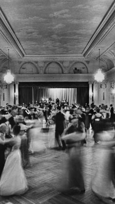 black and white photograph of people dancing in a ballroom