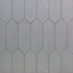 a white tiled wall with small hexagonal tiles