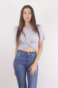 Final Sale-Not eligible for return Cropped tee shirt with knot front detail. Details Banded waist 95% Rayon, 5% Spandex Hand wash recommended, lay flat or hang dry Sizing Model: Height 5'3"| Bust 32"| Waist 25"| Hips 33" Model is wearing a size small Recommended sizing: S: (0-2) M: (4-6) L: (8-10) Although we try to get measurements as accurate as possible, they should still be considered approximate. Trendy Cropped Soft-washed T-shirt, Fitted Cotton Graphic Cropped T-shirt, Casual Gray Cotton Cropped T-shirt, Fitted Cotton Workout Cropped T-shirt, Trendy Stretch Blue Cropped T-shirt, Cropped Tee Shirt, Crop Tee, Gray Color, Mom Jeans