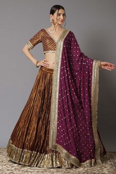 Gold tiered lehenga with gota patti border and scallop detail. Comes with wine blouse and dupatta.
Component: 3
Pattern: Embroidery
Type Of Work: Sequin and Gota Patti
Neckline: V neck
Sleeve Type: Half
Fabric: Metallic Chanderi and Chinon; Lining: Shantoon and Cotton
Color: Purple,Gold
Other Details: 
Dupatta with embroidered border
Low back with tie up and tassels
Closure: Back hook
Occasion: Wedding - Aza Fashions Wine Lehenga, Chanderi Lehenga, Cotton Lehenga, Latest Bridal Lehenga, Purple Metallic, New Address, Embroidered Wedding, Wedding Lehenga, Indian Fashion Designers