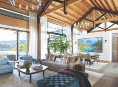 a living room filled with furniture and a chandelier hanging over the top of it