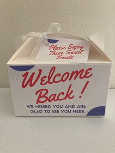 a welcome back box is shown on a table