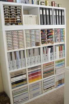 a white book shelf filled with lots of books