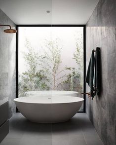 a large white bath tub sitting inside of a bathroom