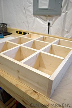 an unfinished wooden box sitting on top of a table