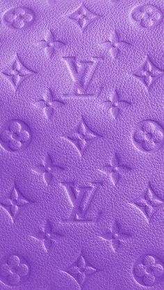 purple leather with the letters louis vuitton written on it in cursive writing