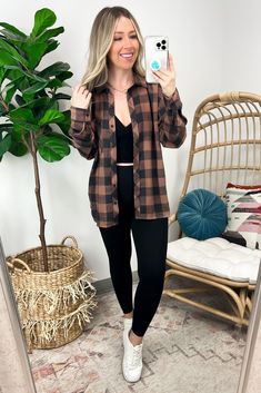 Details: Show off your chill-chic style with this oversized boyfriend flannel. Featuring a dark gingham pattern, turn-down collar, drop shoulder, and open pocket, you'll be lookin' cozy AF in no time. Who needs a real boyfriend when you have this rad shirt?!! - Relaxed fit - Plaid print Content: 65% Polyester 35% Rayon Size + Fit - Models are 5'4" and is wearing a size SM - Measurements from a size SM CHEST: 42" LENGTH: 28.5" WAIST: 42" SLEEVE LENGTH: 25" Brand: BeCool Plaid Layered Outfit, Plaid Shirt Fall Outfit, Earth Tone Flannel, Cute Fall Outfits With Hats, How To Wear Oversized Flannel, Plaid Outfits For Women Flannels, Fall Outfit Flannel, Fannels Shirts Outfits Fall, Outfits With Plaid Shirts Flannels