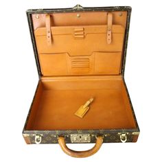 This elegant classeur briefcase features monogram canvas and a comfortable leather handle. Closed by a solid brass lock, it is accompanied by two crafted brass trunk latches. Its trims are printed with the LV logo all around. Its interior has a removable filing system which includes a place for pens, pencils, credit cards, calculator, notepad and folders. The large compartment is particularly convenient with a sturdy strap to keep all your files or paperwork in place. Embossed serial number insi Brass Trunk, Logo Lv, Louis Vuitton Luggage, Lv Logo, Lock It, Inside Bag, Filing System, Pens Pencils, Monogram Canvas