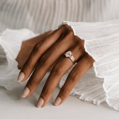 a woman's hand with a diamond ring on it