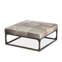 a square footstool sitting on top of a white floor