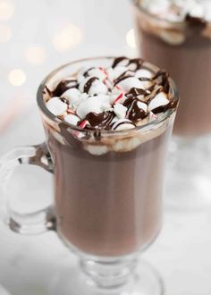 two glasses filled with hot chocolate and marshmallows