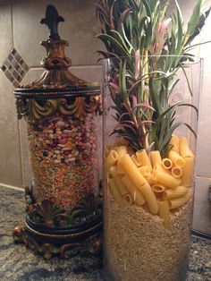 two vases filled with different types of pasta