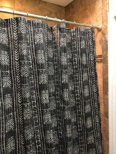 a bathroom with a black and white shower curtain