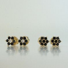 Dainty flower shaped stud earrings. Perfect for pairing with multiple piercings. Available in Black or Black with White CZ Stone DETAILS * Thick plating of 14k Gold or Rhodium over 925 Sterling Silver * Sold as a Pair * Hypoallergenic and nickel-free * 5 mm x 5 mm * Also available in white cz, ruby, sapphire or emerald Huggies on Model: https://www.etsy.com/listing/708078947/sapphire-huggie-earrings-gold-cz-huggies?ga_search_query=black%2Bhuggies&ref=shop_items_search_1&pro=1 Made with 1 Black Flower Earrings As Gift, Black Flower Drop Earrings For Gift, Black Diamond Earrings For Gift, Black Flower Shaped Earrings For Gift, Black Flower-shaped Earrings For Gift, Stud Earrings Black, Black Studs, Huggie Earrings Gold, Small Stud Earrings