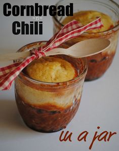 two jars filled with food sitting on top of a table