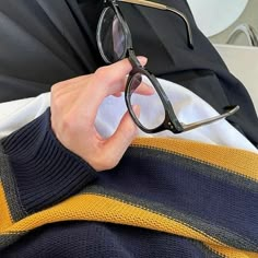 a person wearing glasses while sitting down