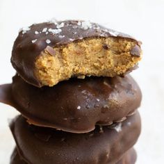 three chocolate covered cookies stacked on top of each other