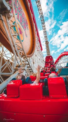 people ride on the roller coaster at an amusement park