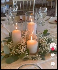 a table with candles and flowers on it