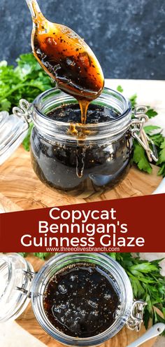 a glass jar filled with black sauce sitting on top of a cutting board