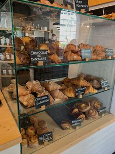 a display case filled with croissants and other pastries