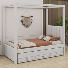 a white bed with drawers underneath it and a plant on the wall next to it