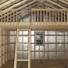 a loft with a ladder and windows in the ceiling, surrounded by wood planks