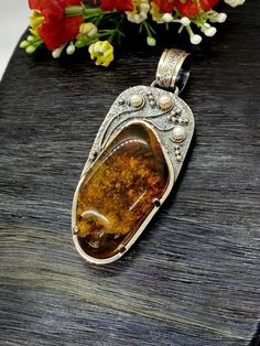 Artisan Amber with pearls pendant  Hand-made Sterling Silver 925.  Stones used: Baltic Cognac Amber, Pearls.  Height -3 2/16” (with bail), Width – 1 3/16”  Height – 80mm, width-30mm.Unique Handcrafted One-of a-kind Design PendantEach Piece of Jewelry in my Collection is Absolutely One of a Kind!When you start wearing a piece of my jewelry you will fall in love with it more and more each day and feel that good Energy and Love that I pass into it while creating this piece of Art.A piece of Art cre Handmade Amber Sterling Silver Jewelry, Artisan Amber Cabochon Necklace, Artisan Amber Sterling Silver Jewelry, Amber Cabochon Artisan Necklace, Unique Pearl Pendant Jewelry, Cabochon Pendant Amulet Jewelry, Cabochon Amulet Pendant Jewelry, Artisan Sterling Silver Pearl Pendant Jewelry, Antique Pendant Jewelry With Natural Stones