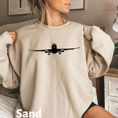 "Best gift for Airplane Sweatshirt, Travel Shirt, Gift for Traveler, Adventurer Gift, Airplane Shirt, Vacation Sweatshirt, Pilot Sweatshirt --------HOW TO ORDER----------- 1)select your SWEATSHIRT Size 2)select your desired Color 3)Double-check the SIZE chart to find your fit 4)click \"Add to Cart\" and continue shopping to add another sweatshirt for your loved ones.  Browse our selection of more Vacation and Happy Vibe shirts/sweatshirts ------ https://www.etsy.com/shop/KenzAmericanTee?ref=seller-platform-mcnav&section_id=40862988 Our T-shirts, crewneck Sweatshirts and Hoodies quality is top-notch and can be used everywhere in daily life. ✿ Sweatshirt Material We use Gildan 18000 Unisex CrewNeck Sweatshirt * 50% cotton, 50% polyester * Pre-shrunk, Classic fit, very soft feel. ✿ Size All o Casual Long Sleeve Tops For Travel, Pilot Husband, Hoodie Photo, Pilot Wife, Airplane Shirt, Gift For Traveler, Belly Shirts, Colorful Sweatshirt, Adventure Gifts