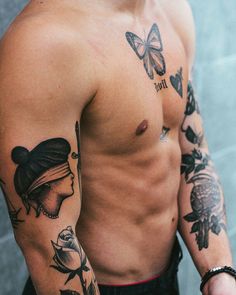 a shirtless man with tattoos on his arm