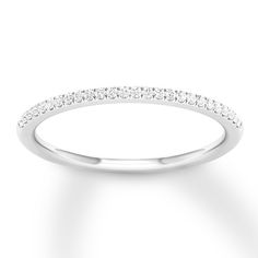 a white gold wedding band with rows of diamonds