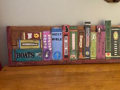 a wooden shelf filled with books on top of a table