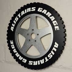 a black and silver sign on the side of a white wall that says all - stars garage