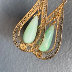 Delicate ~ Vintage Art Deco ~ Chinese carved Jade jadeite ~ solid 14kt yellow gold filigree and natural pearl dangle drop screw-back earrings ~ Marked 14kt for gold (also acid tested ). Dates first half of 20th century . Measurements : Earrings are 2 inches in drop length x 5/8 inches max width Weighs 8 grams on my weighing scale. Condition : Overall in good vintage condition ~ I did not see any chip to the stone ~ Some surface wear to the metal and pearls . Please Note ~ As vintage items are pr Fine Gold Jewelry, Carved Jade, Weighing Scale, Jade Carving, Natural Pearl, Gold Filigree, Screw Back Earrings, Natural Pearls, 14kt Gold