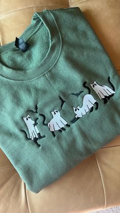 Adorable sweatshirt featuring ghost cats!   Unisex sweatshirt offers a relaxed fit for all genders and body types. Comfortable and warm which is perfect for fall nights and Halloween fun. INFORMATION * Gildan Unisex Sweatshirt * 50% Cotton, 50% Polyester -Design is embroidered with high quality thread CARE INSTRUCTIONS Machine wash cold on delicate cycle, dry low heat or lay flat to dry. Do not bleach/dry clean.  SIZING Unisex sized.  Please refer to guide size photo to determine the most accurate fit & for all measurements and information. SHIPPING We require 3-5 days for processing time- Rush option is available. Please contact me to discuss. Please allow another 2-10 days for delivery. Please ensure your selections are correct as I do not accept returns. Size Chart S M L XL 2XL Fall Crew Neck Sweater With Cat Design, Crew Neck Sweater With Cat Design For Fall, Fall Long Sleeve Hoodie With Cat Print, Casual Cat Design Sweatshirt For Fall, Fall Cotton Sweater With Cat Print, Relaxed Fit Long Sleeve Sweatshirt With Cat Print, Cotton Crew Neck Sweatshirt With Cat Design, Cotton Crew Neck Sweater With Cat Design, Casual Halloween Sweatshirt With Cat Design