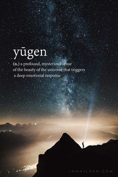 a person standing on top of a mountain under a night sky with the words yugen