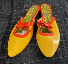 These are the cutest shoes I've gotten in a really really long time! So 60's! So MOD! Bright orange and yellow. Little orange bows. Amazingly lined with groovy flowers. I don't think these were ever worn. They are vinyl. They have sat in storage for a long time so they bend in a bit and just need to be worn. Back stickers are marked with price tags and "Vinyl Upper & Sole...Size 9...A Quality Product Made in Japan.  These are very very narrow and need a slim foot. Bottoms look like new. There was some glue residue on the edges I removed most of but you can still see a hint of it in certain spots. Vinyl is really nice and not cracked. Soles don't feel dry either. So cute They are still vintage of course and not a new shoe. Please see photos! Vinyl Shoes, Cutest Shoes, Groovy Flowers, Yellow Flats, Orange Bows, 60s Mod, Vintage Orange, Price Tags, 1960s Vintage