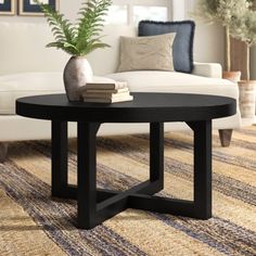 a living room with a white couch and black coffee table