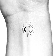 a black and white photo of a sun and moon tattoo