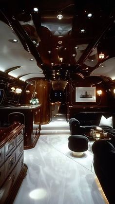 the interior of a luxury vehicle with black furniture and lights on it's walls