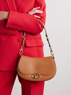 Valentino Garavani's 'Ohval' shoulder bag is designed with gold-tone hardware, including the 'VLOGO' that doubles as a twist-lock fastening. It's been made in Italy from light-brown leather contrasted by white topstitching along the curved flap and has detachable straps that allow you to change up the way you carry it. It's perfectly sized to hold your phone, a full-sized wallet and sunglasses. Denim Flats, Bags 2024, Valentino Garavani Bag, Flat Dress Shoes, Floral Dresses Short, Light Brown Leather, Sport Swimwear, Sports Skirts, Designer Crossbody Bags