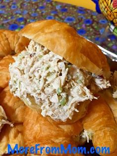 there is a croissant with chicken salad on it