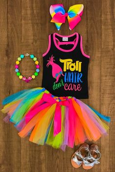 a black tank top and rainbow tutu skirt