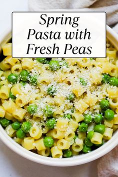 spring pasta with fresh peas and parmesan cheese in a bowl on a white surface