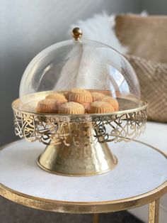 Indulge in the perfect blend of tradition and luxury with our Golden Arabesque Dessert Dome. Crafted with elegance, this exquisite piece features intricate Arabic calligraphy interwoven into a delicate lattice design, wrapping around the gleaming brass base and complementing the transparent dome. The dome itself is made from high-quality clear material, allowing for a tempting display of your finest confections, like the baklava showcased within. Designed to captivate and impress, this dessert d Royal Cakes, Round Cake Stand, Lattice Design, Decorative Trays, Baklava, Arabesque, Decorative Storage, Cake Stand, Tray Decor