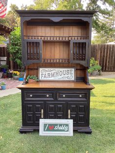 an old fashioned wooden hutch sitting in the grass