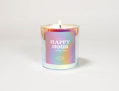 a candle that says happy hour sitting on a white surface with the words happy hour printed on it