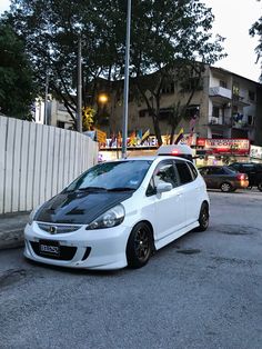 a small white car parked on the street